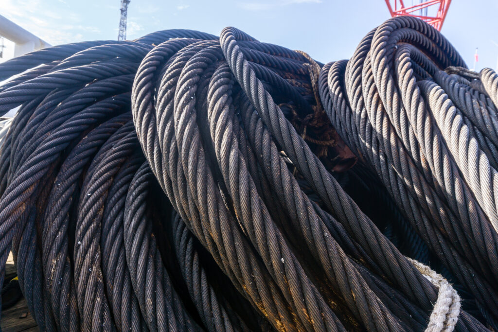 Coil of anchor penant wire rope on deck of a construction barge at oil field