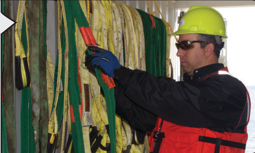 Construction worker adjusting crosby sling saver